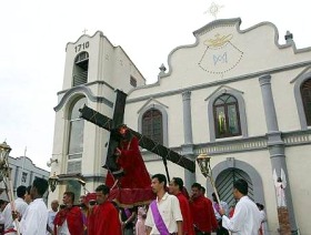 Picture: Reverent: The statue of Christ carrying the cross being taken out of the church to begin the procession"