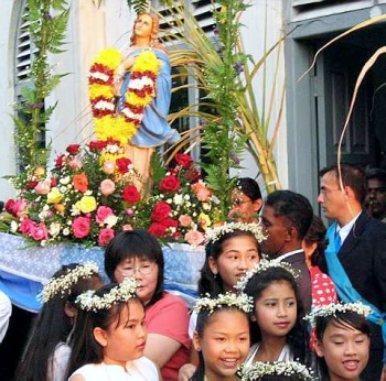 Image: The statue of Our Lady of the Rosary being carried in procession with sugar cane stalks in the background at the Assumption Chapel in Malacca recently"