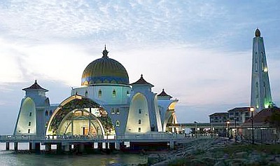 Image: Majestic: The Straits Mosque (Masjid Selat) in Pulau Melaka decorated with colourful lights in the evening."