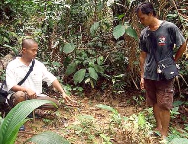 Image: Ancient site: Zurdi Baharu (left) and his friend Sebastian Kessu showing the site of one of the graves."