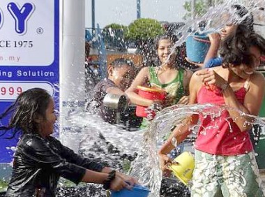 Image: Residents having fun splashing water on each other"