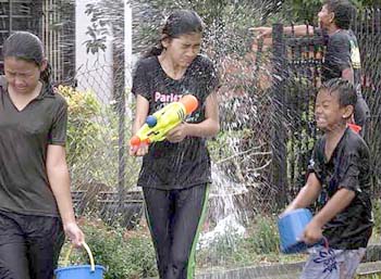 Image: Young ones, teenagers and adults having a real water splashing time."