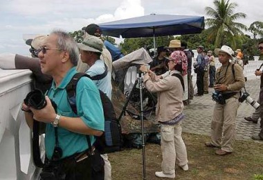 Image: Avid bird watchers at Tanjung Tuan scanning the skies for the migratory birds."