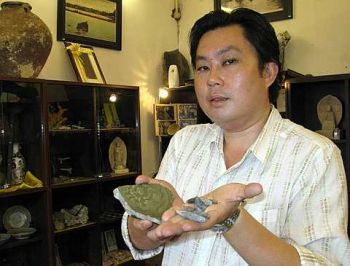 Image: Jason Yoong showing off the celadon shard and tin piece found here over the years that support the 1278 founding year."